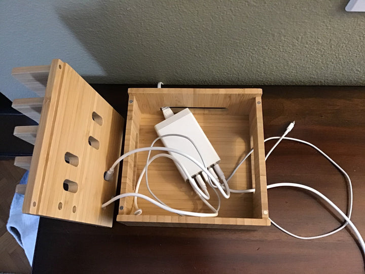 Compact bamboo 5-port charging station for efficient multi-device charging and organized desk cable management.