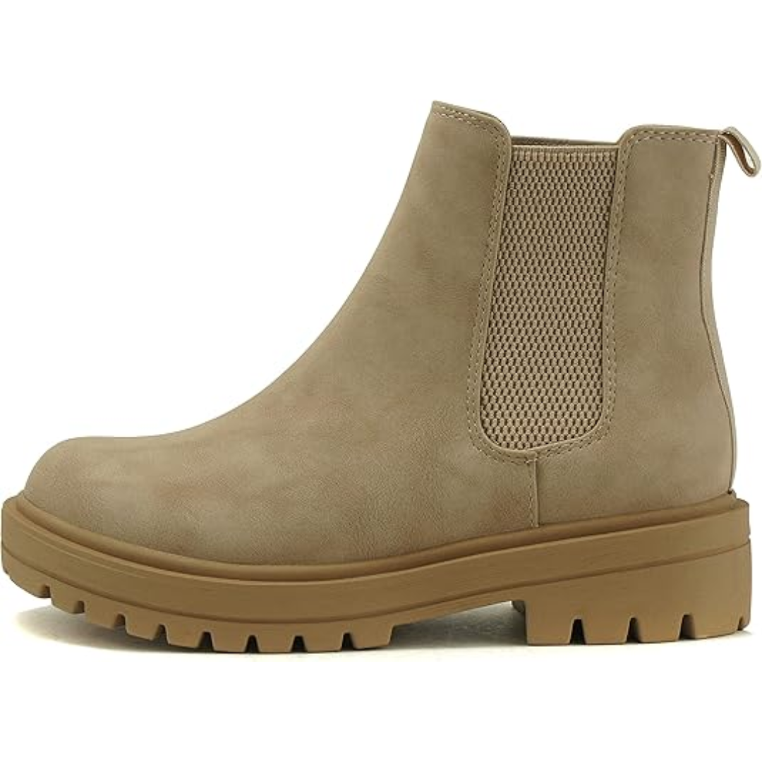 Women's Chelsea ankle boots styled with jeans, showcasing comfortable low heel and trendy casual fall footwear.