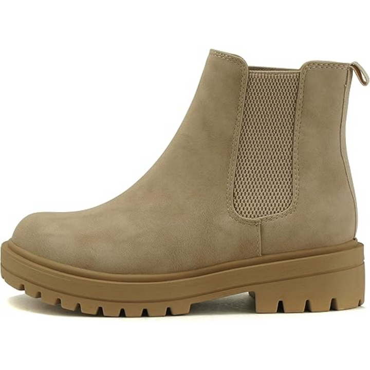 Women's Chelsea ankle boots styled with jeans, showcasing comfortable low heel and trendy casual fall footwear.