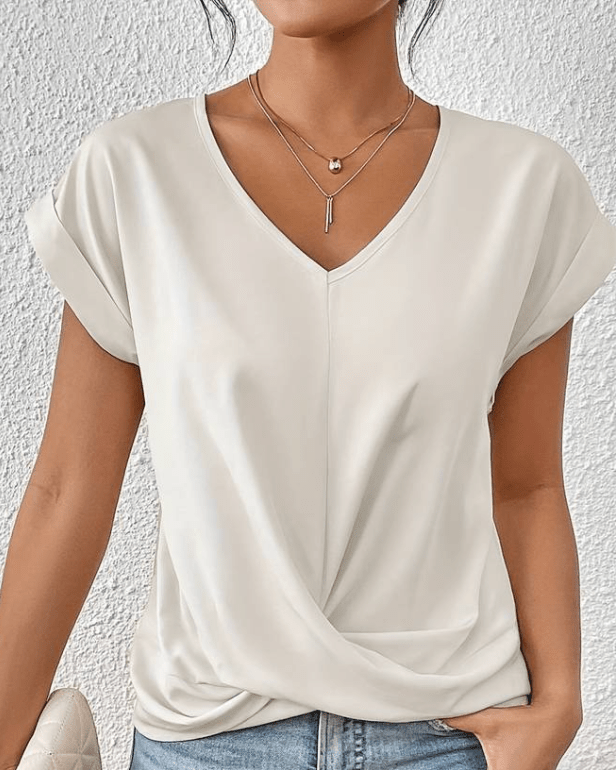 Relaxed fit women's V-neck top featuring a chic twist hem and comfortable short sleeves for versatile style.