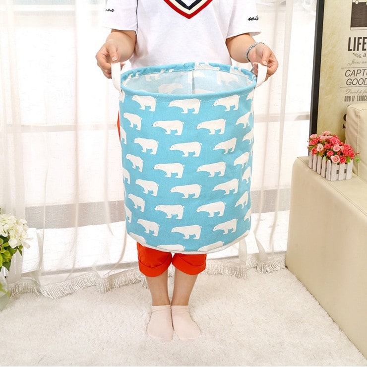 Collapsible canvas laundry hamper with sturdy handles, perfect for space-saving home organization.