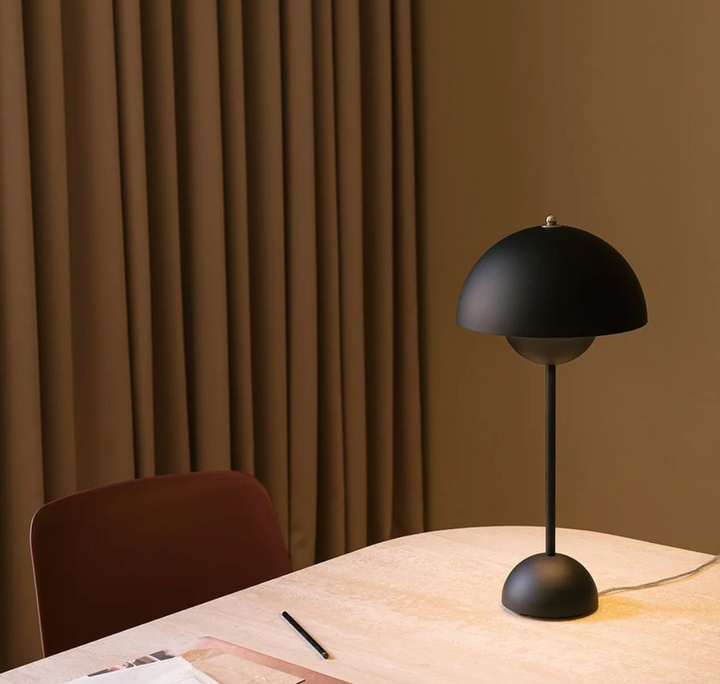 Cordless LED table lamp with distinctive umbrella design, retro style, provides portable ambient light.