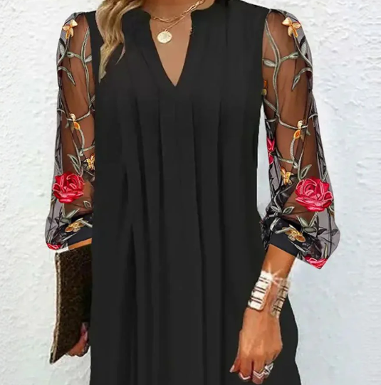 Women's knee-length formal dress, black with delicate floral pattern & sheer long sleeves. Ideal party wear.
