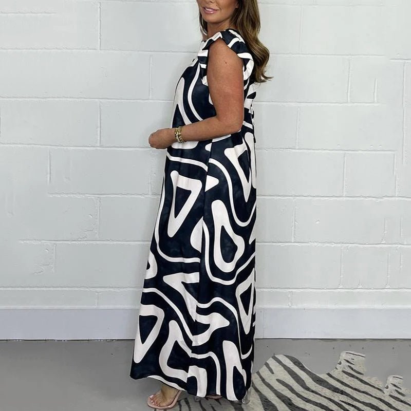 Back view of a women's wide-leg maxi jumpsuit with unique abstract print, ideal for elegant summer fashion.