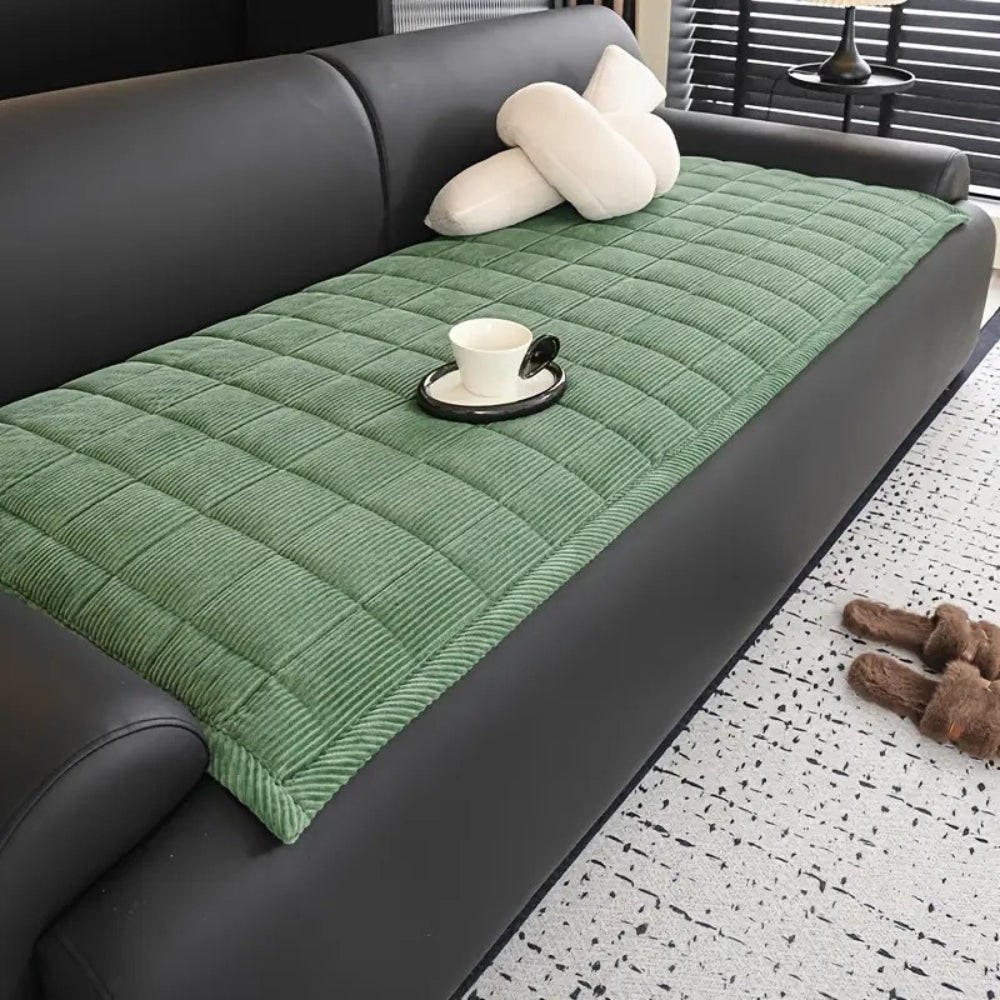 Soft microfibre quilted couch cover, an effective pet-friendly sofa protector.