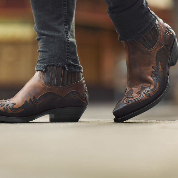 Timeless men's western ankle boots, pointed toe, offering rugged durability & style.