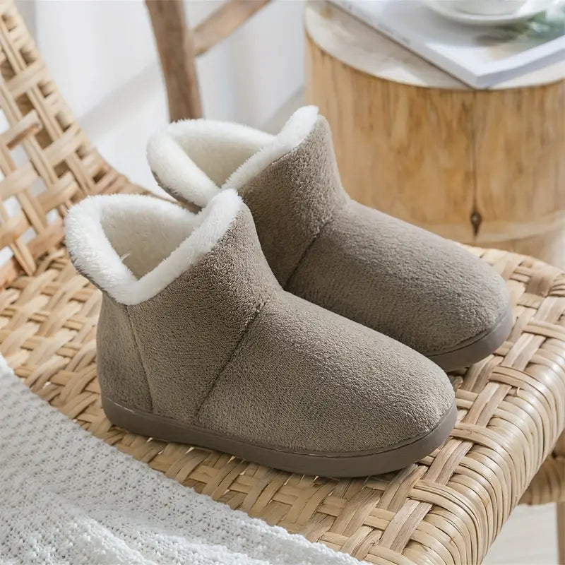 Soft women's ankle bootie slippers with plush lining for cozy warmth; ideal indoor house shoes.