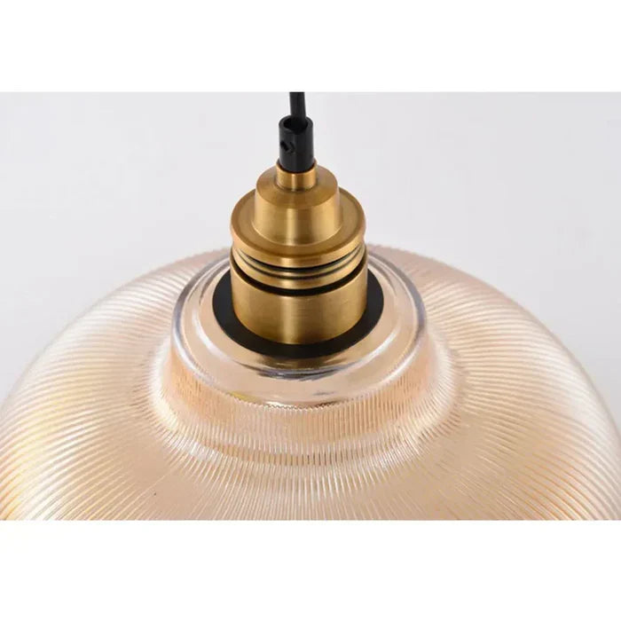 Close-up of stylish CrystalLoom amber glass pendant light. Modern ceiling fixture, elegant home decor lighting.