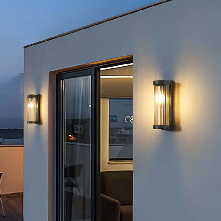 Cylindrical metal & glass solar pathway lamp. Modern outdoor LED garden light, weatherproof for paths.