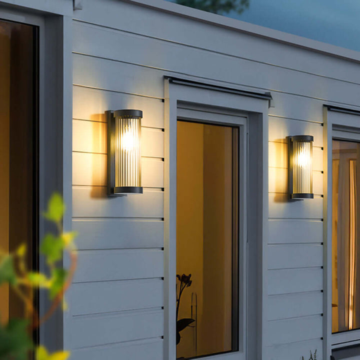 Outdoor cylindrical solar pathway light. Contemporary metal & glass design, energy-efficient LED for gardens.