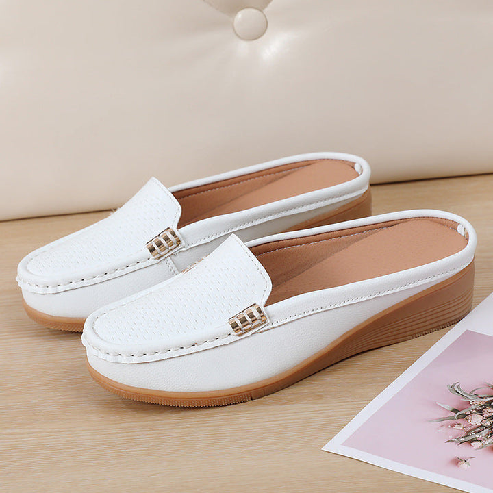 Women's stylish wedge mules, comfortable slip-on footwear with a perforated design.