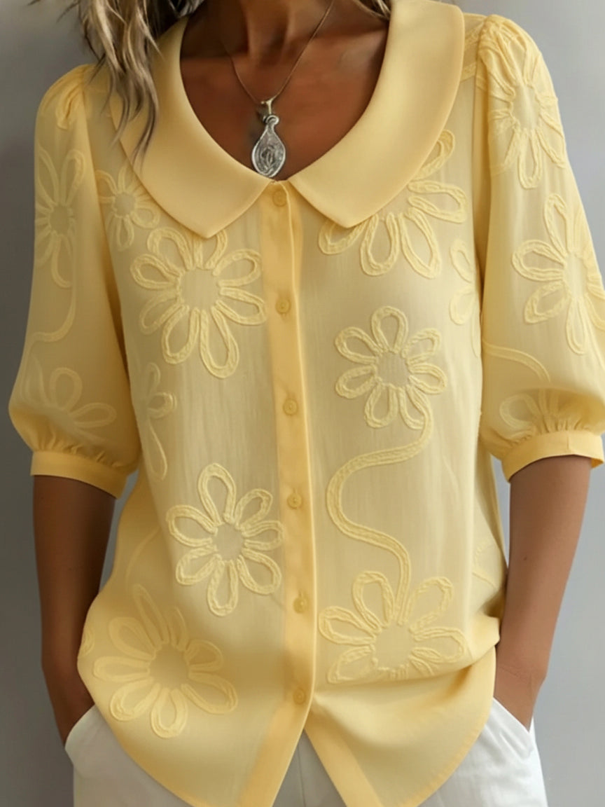 Women's knit floral blouse with classic Peter Pan collar & half sleeves. Elegant top for spring/summer fashion.