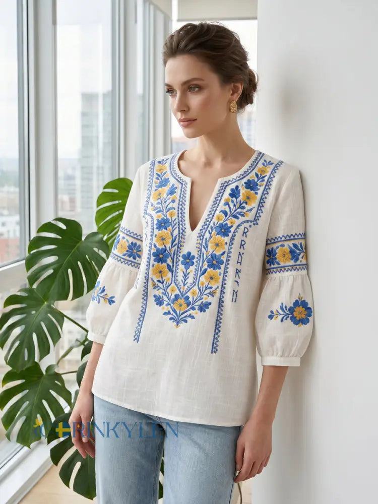 Relaxed fit women's bohemian style blouse with V-neck, intricate embroidery, and comfortable fabric for everyday wear.