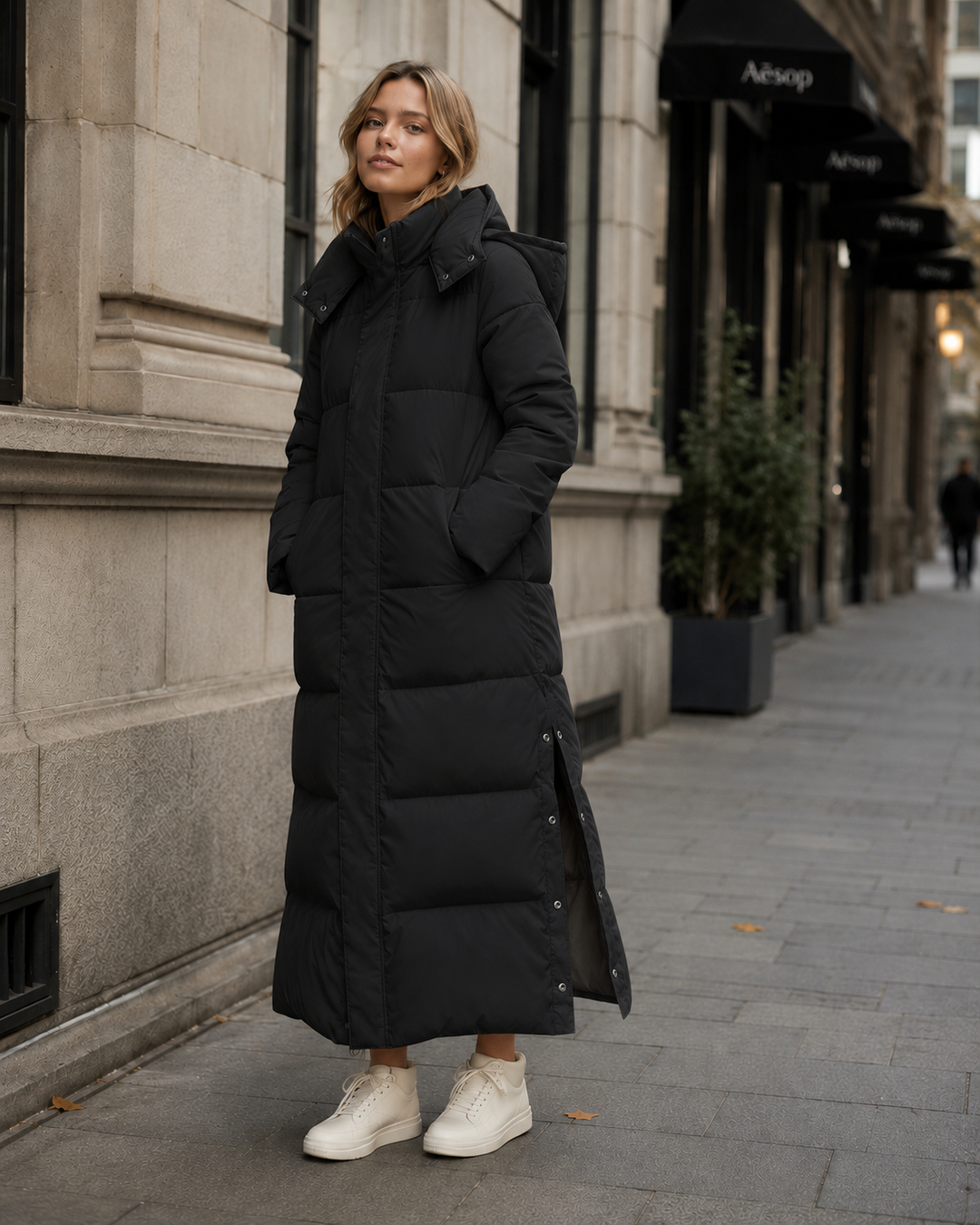 Stylish women's black windproof long winter jacket. Relaxed fit for daily cold weather fashion.