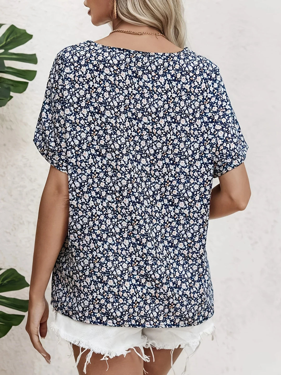 Ladies ditsy floral print button-up blouse. Relaxed fit short sleeve top for everyday warm weather fashion.