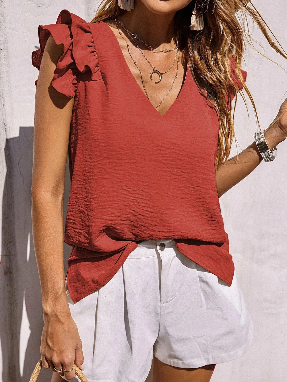 Stylish women's summer top featuring a V-neck and delicate ruffle sleeves, chic & comfortable.