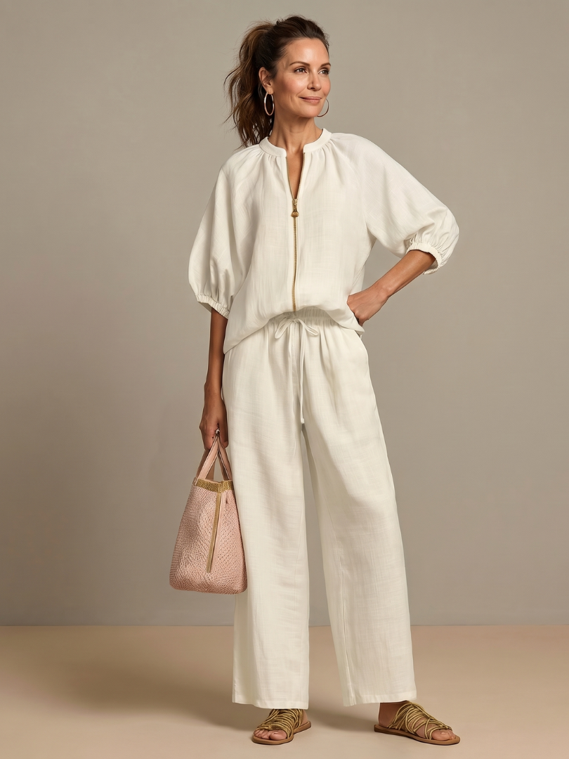 Side profile of the women's co-ord set: relaxed wide leg pants & fashionable zip-front top.