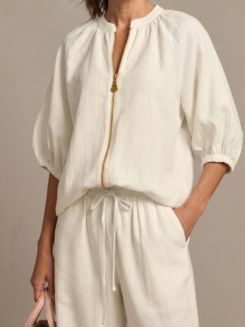 Modern women's two-piece set: wide leg pants & zip-front top, suitable for various occasions.
