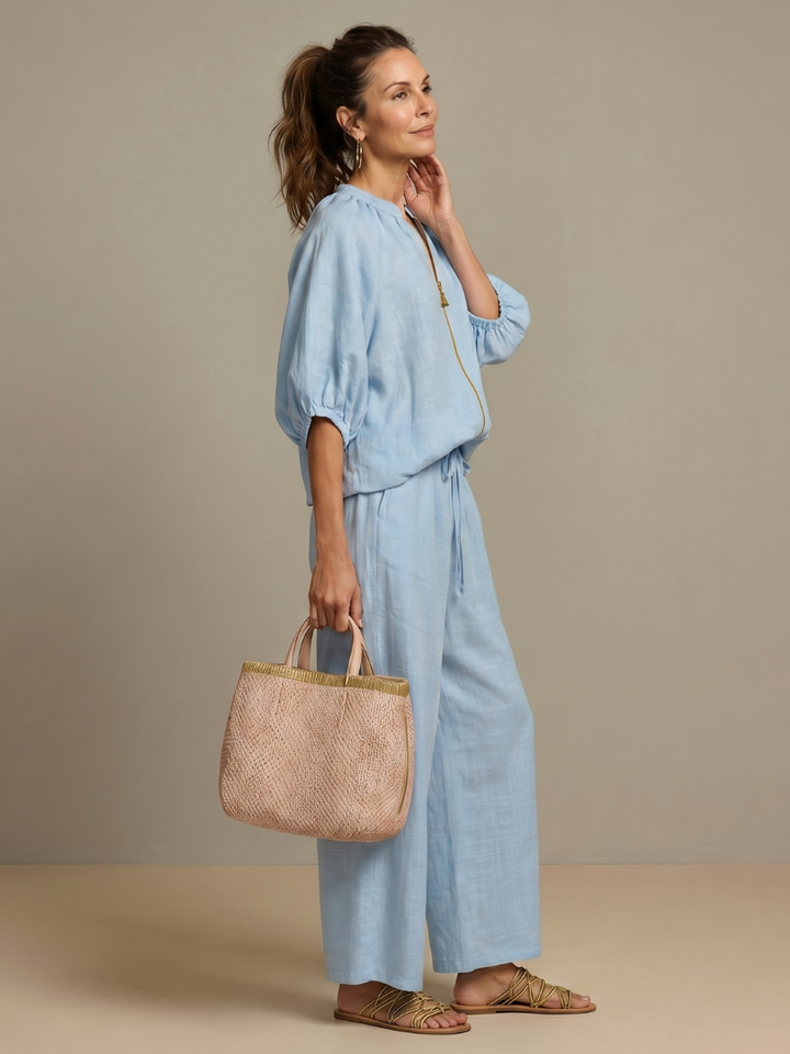 Elegant comfort: Women's two-piece outfit featuring relaxed wide leg pants & zip top.