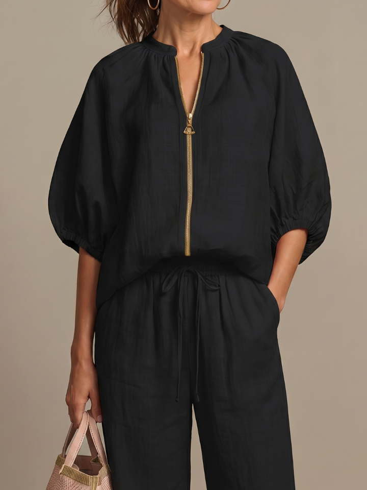 Versatile women's co-ord set in a solid color, featuring wide leg pants & a zip-front top.