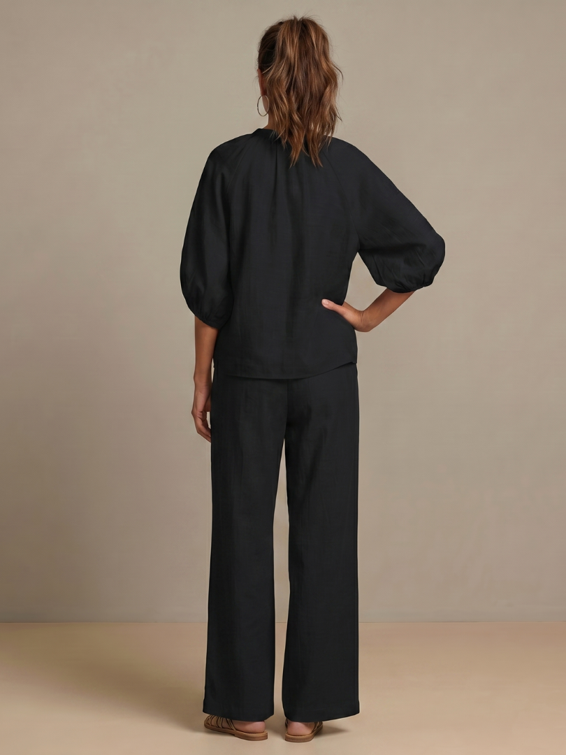 Dynamic shot of a woman walking in the women's co-ord set: wide leg pants & zip-front top.