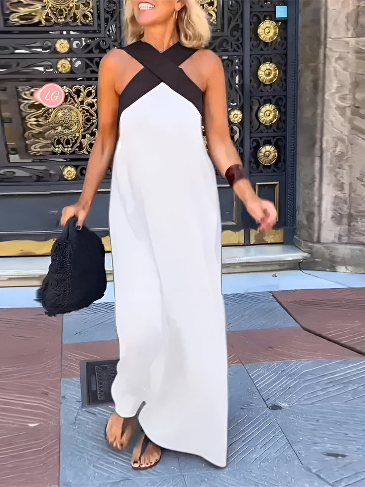 Flowy two-tone women's maxi dress with a stylish crossover halter neckline, perfect for summer.
