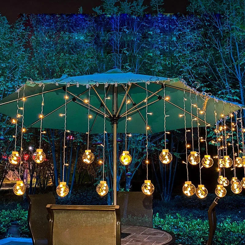 Festive waterproof LED string lights draped for a lively outdoor party decor. Ideal for event ambiance.