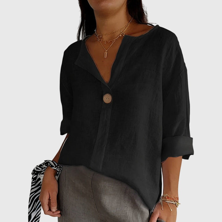 Professional women's V-neck button-front blouse in a classic design. Ideal for office attire or smart casual.