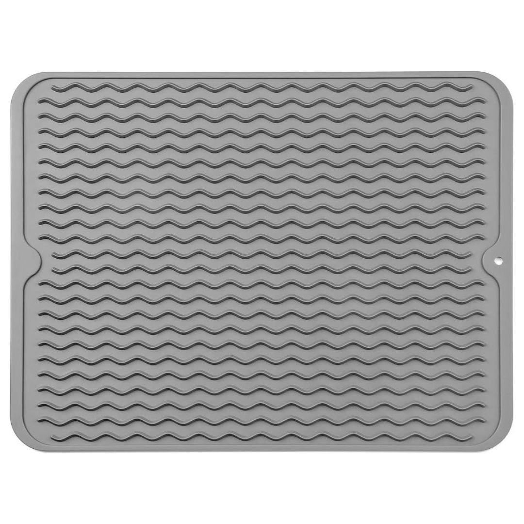 Gray silicone drying mat for dishes & glassware, protecting kitchen countertops from water and scratches.