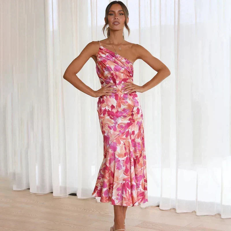 Beautiful women's floral midi dress in an elegant pink hue with a chic asymmetrical one-shoulder cut.