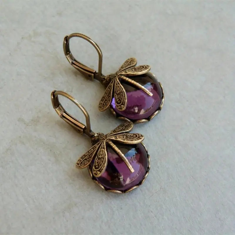 Stunning women's drop earrings: sterling silver dragonflies with shimmering moonstone accents.