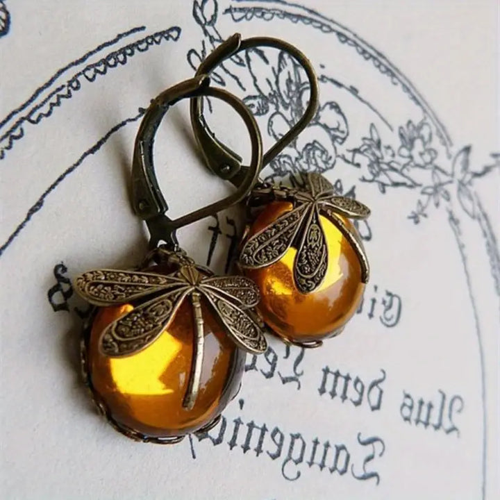 Elegant women's dragonfly drop earrings with iridescent moonstone, crafted from sterling silver.