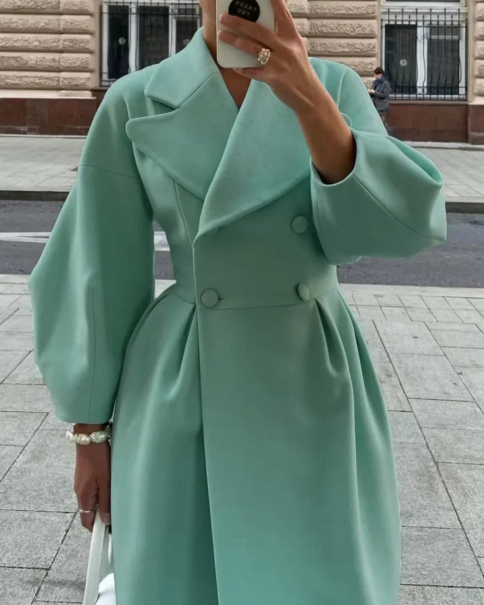 Elegant women's double-breasted long wool coat for a refined and warm autumn look.