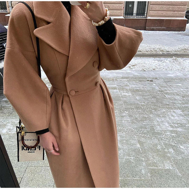 Women's classic double-breasted long wool coat, timeless elegance for cold weather.