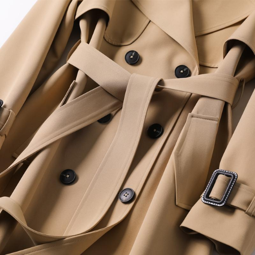 Chic women's long trench coat, double-breasted design for classic and elegant fall fashion.