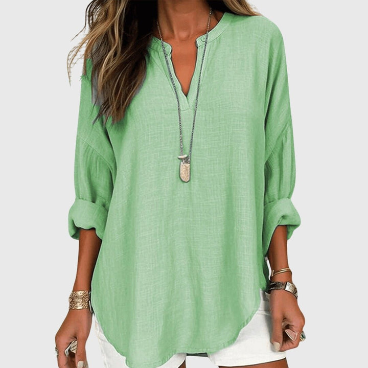 Relaxed fit women's tunic shirt, featuring a V-neck and long sleeves, ideal for casual comfort.