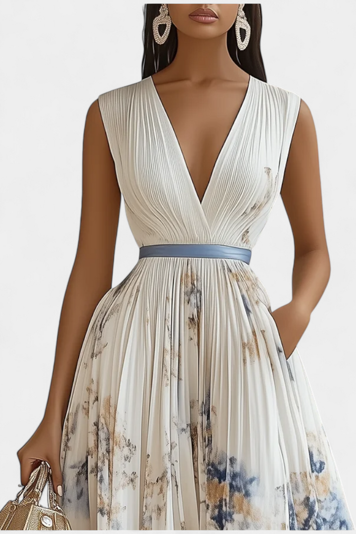 Close-up of elegant women's pleated floral print midi dress, showcasing vibrant pattern and flattering A-line cut.