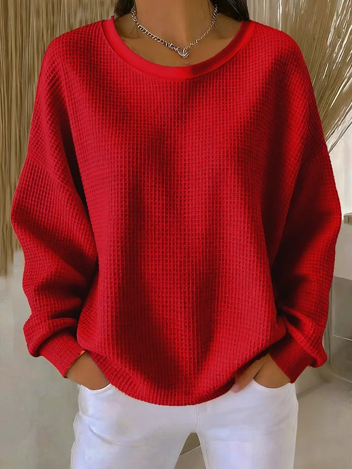 Soft textured women's pullover sweater with a classic round neck and long sleeves.
