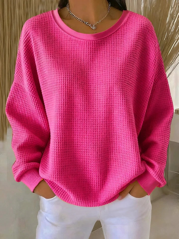 Fashionable women's textured knit sweater with a round neck and comfortable long sleeves.