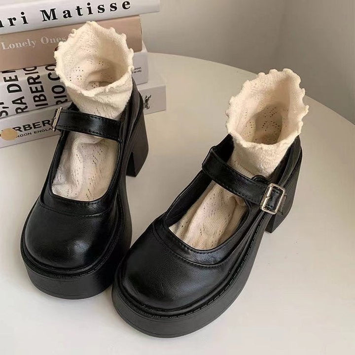 Women's black chunky platform Mary Jane heels with buckle strap, ideal for elegant retro style or workwear.