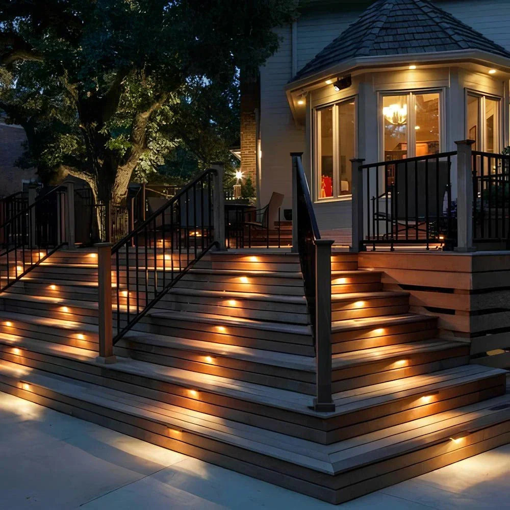 Close-up of Nvroome solar step light illuminating a wooden deck stair with a warm glow.