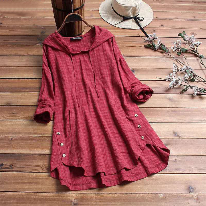 Casual women's hooded tunic shirt with long sleeves and a button hem. Essential for versatile autumn fashion.