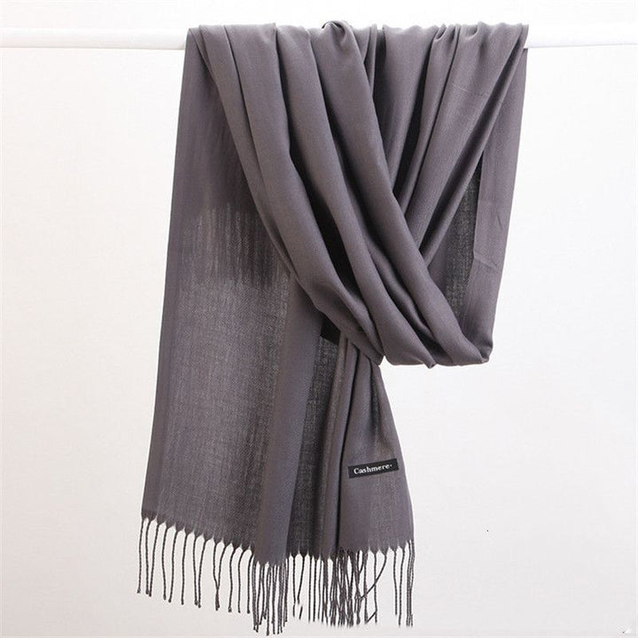 Luxury cashmere scarf, soft texture and solid color for versatile styling in winter.