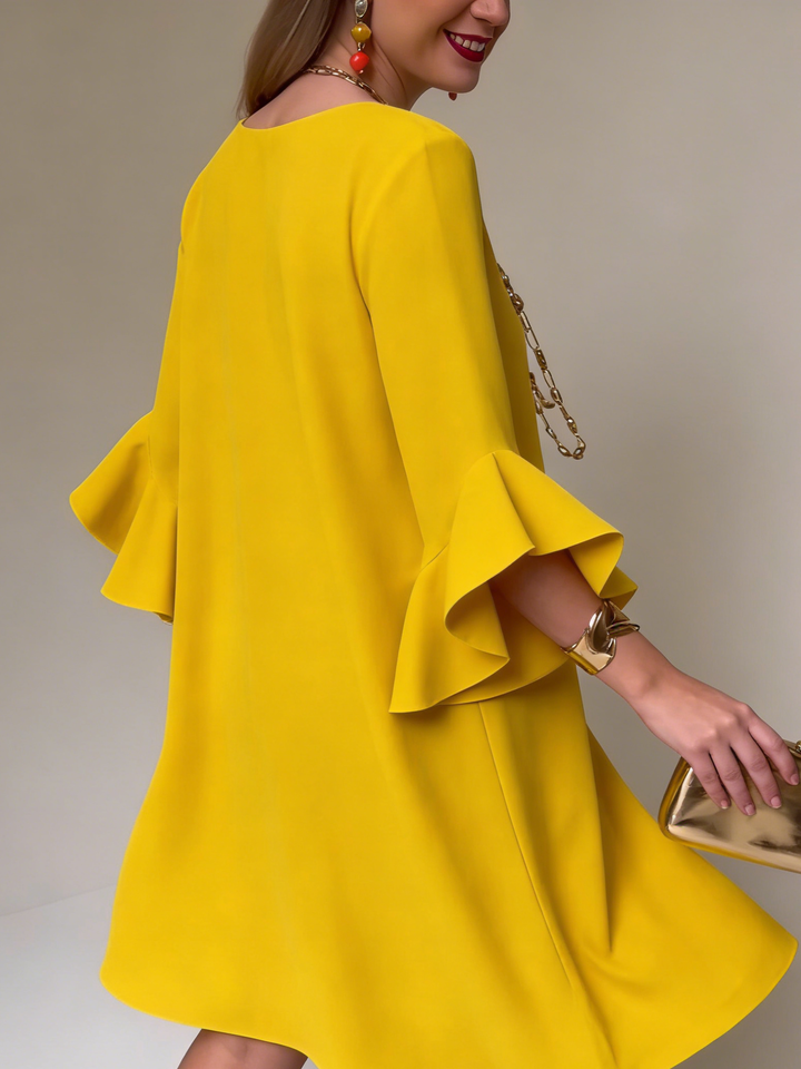 Women's elegant shift dress with delicate ruffles & flowing bell sleeves for a sophisticated look.