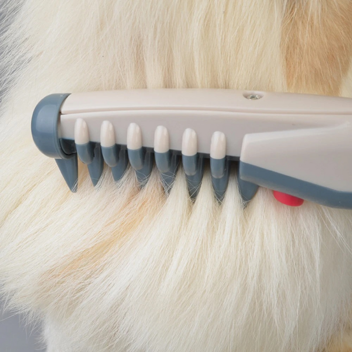 Cat being groomed with the gentle Knot-Free Pet Trimmer. Painless cat grooming tool for smooth, tangle-free fur.