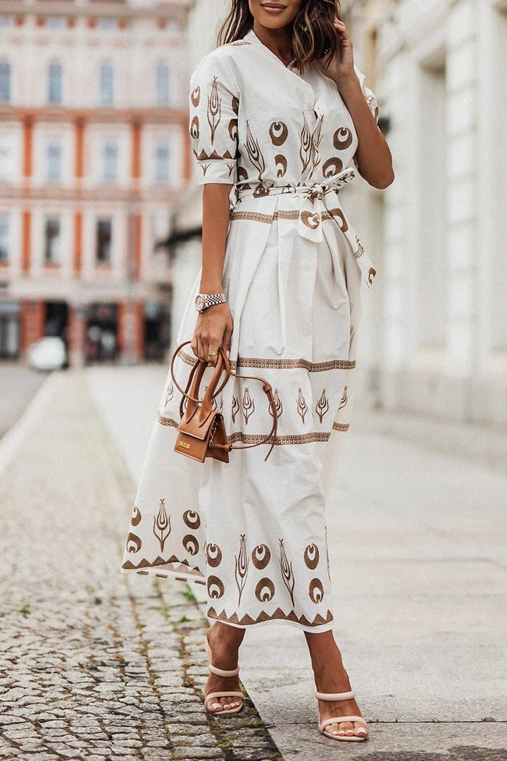 A-line midi cocktail dress for women with bold geometric print, mock neck, 3/4 sleeves, and chic belted waist.
