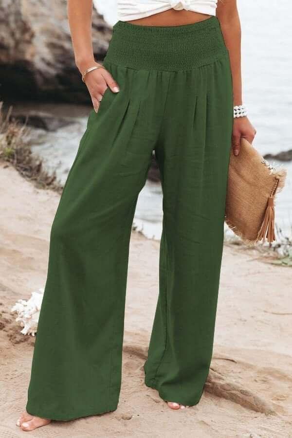 Women's high-rise wide-leg pants featuring a smocked waist. Flowy & comfortable summer beachwear.