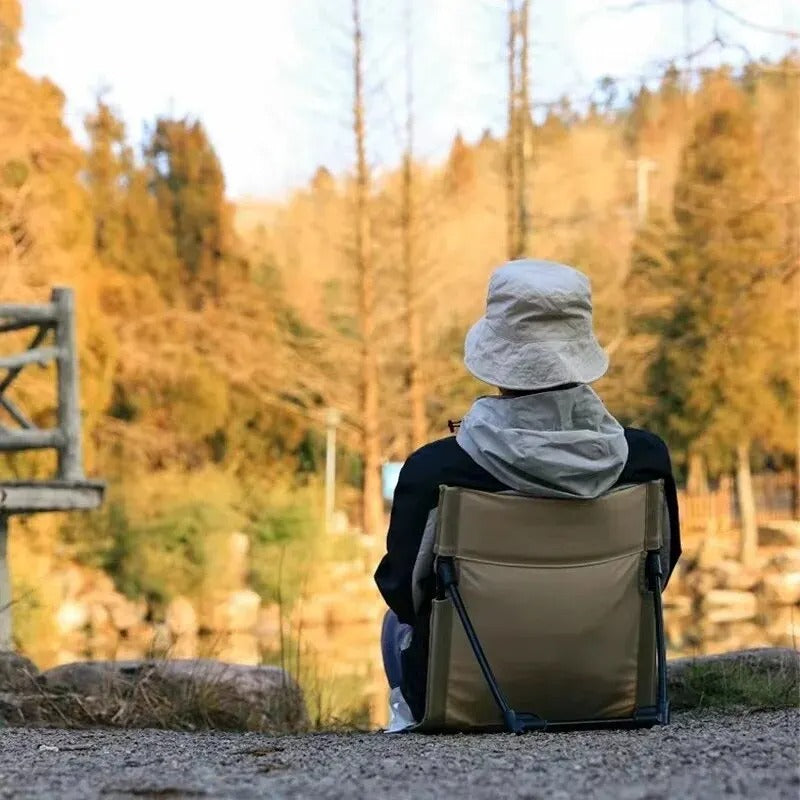 Durable unisex portable beach chair designed for comfort, featuring strong back support for long hours outdoors.