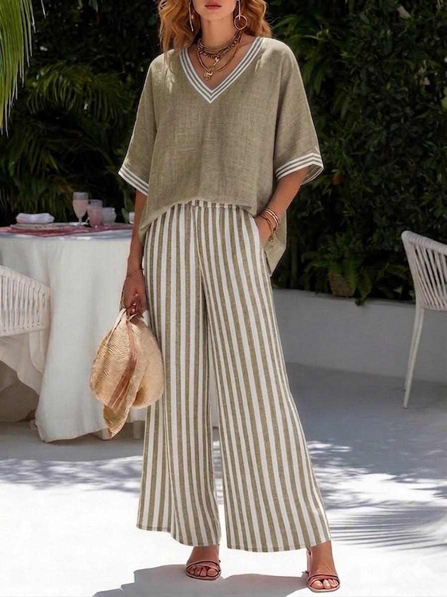 Model wearing women's striped V-neck top & wide-leg pants set, showcasing effortless casual spring fashion.