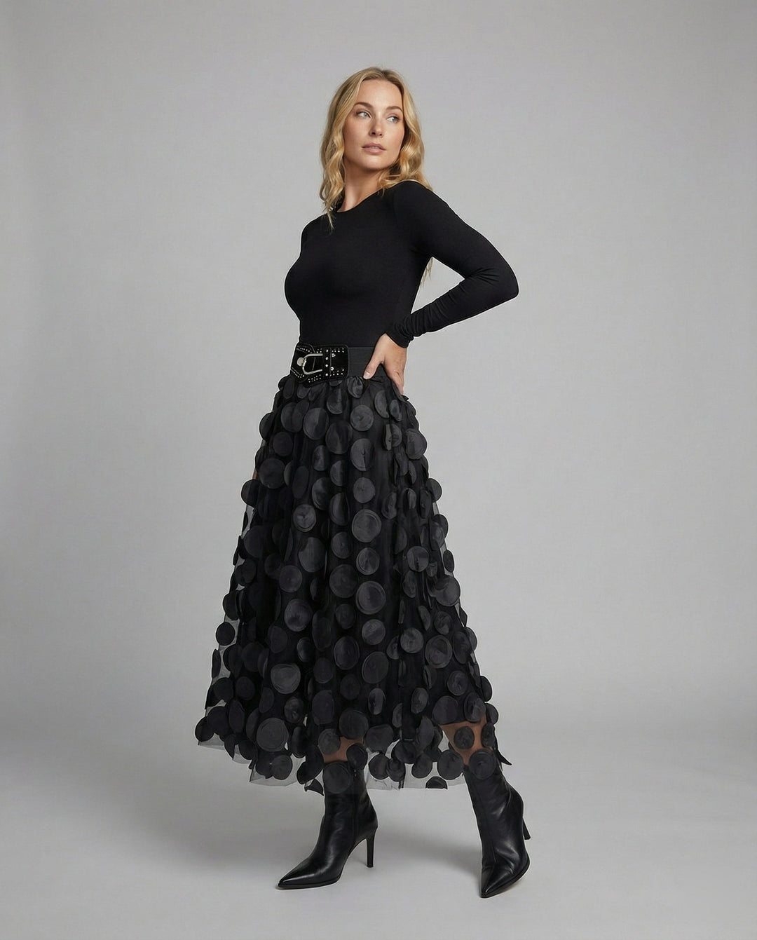 Textured A-line midi skirt featuring a chic polka dot pattern, ideal for evening wear.